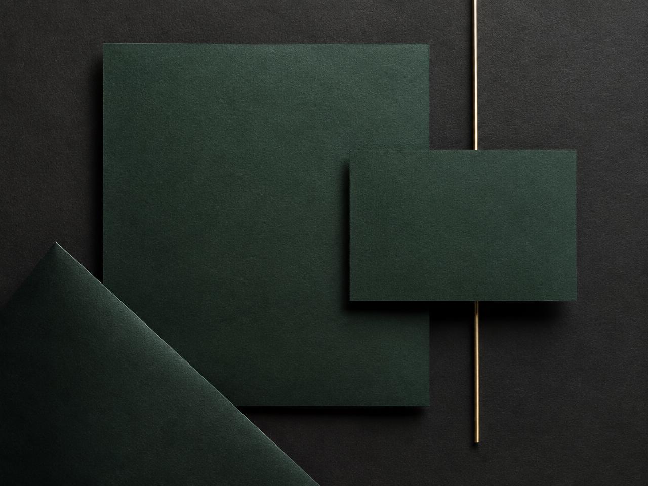 Layered deep green cards on a charcoal surface representing brand work in Canada